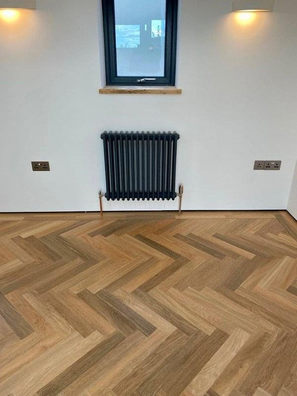 Living room with large windows and new light wood flooring Bristol
